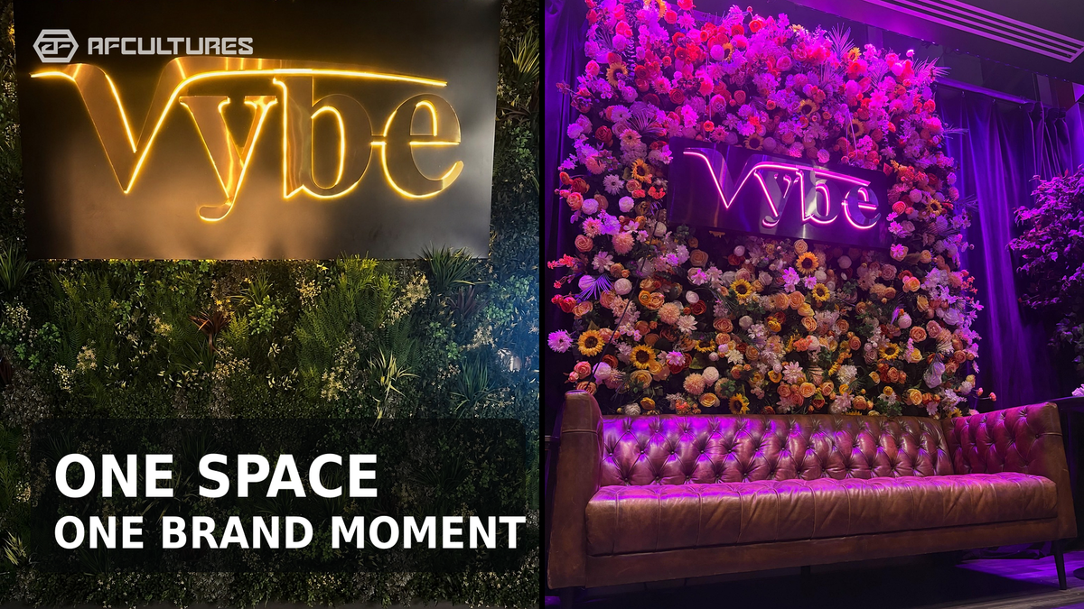 VYBE restaurant interior sign integrated with a floral feature wall