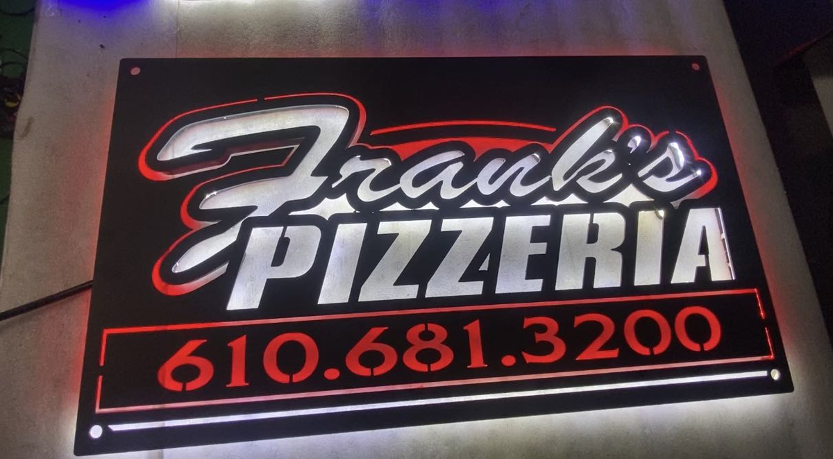 metal sign for franks pizzeria restaurant and bar