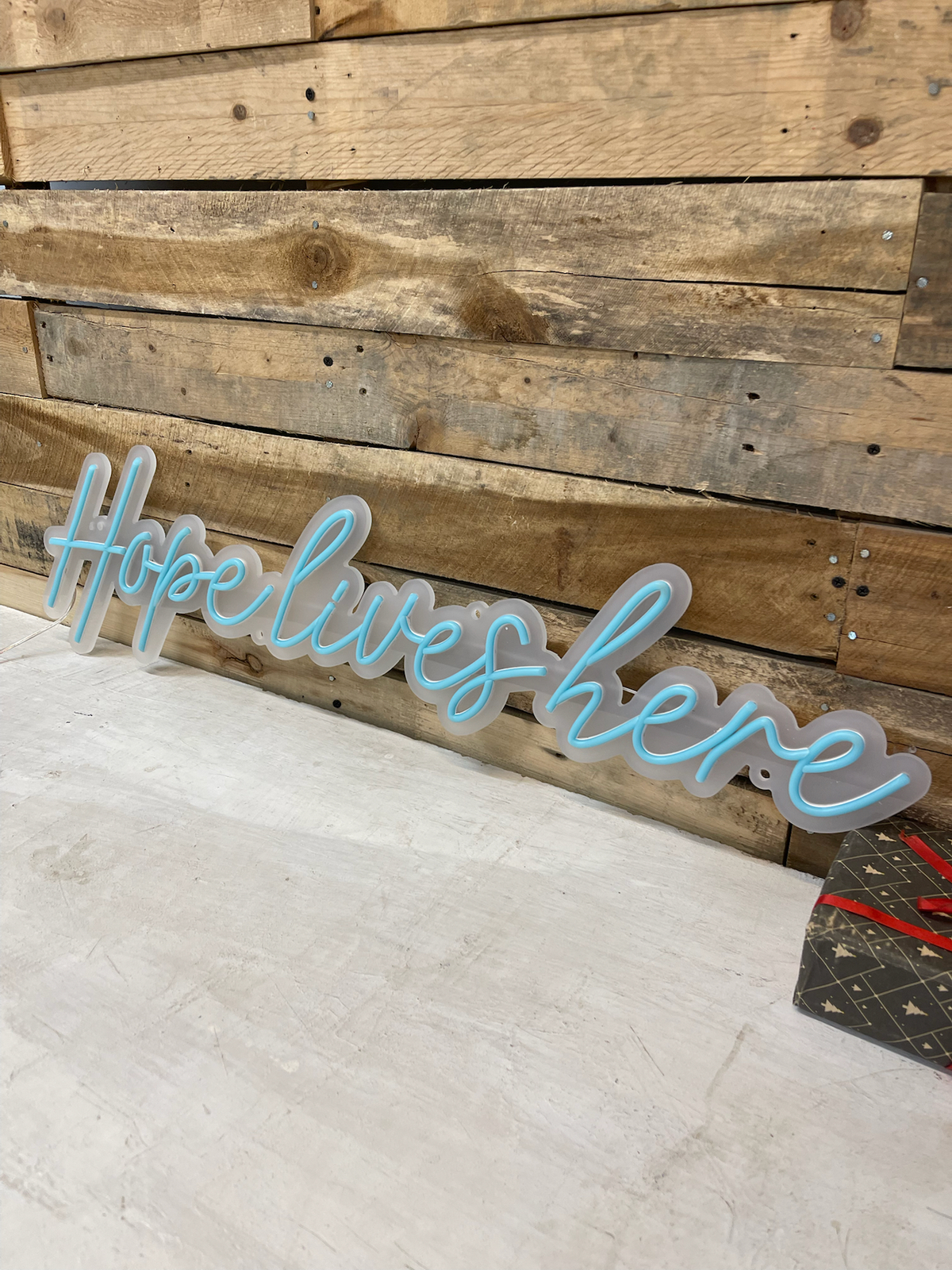 hope lives here podcast logo with led neon flex signs in background