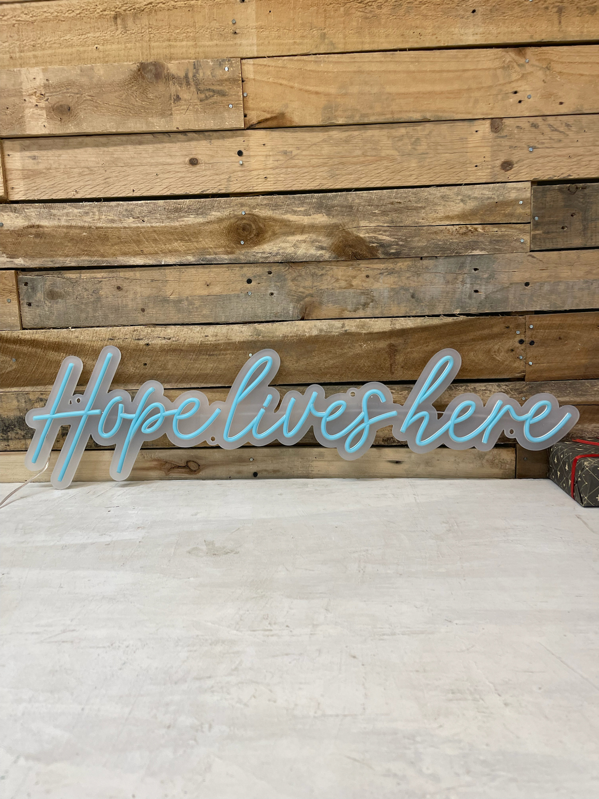 hope lives here podcast logo with led neon flex signs in bright studio setting