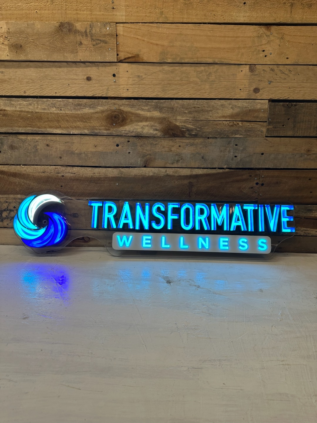 transformative wellness healthcare metal signs on display