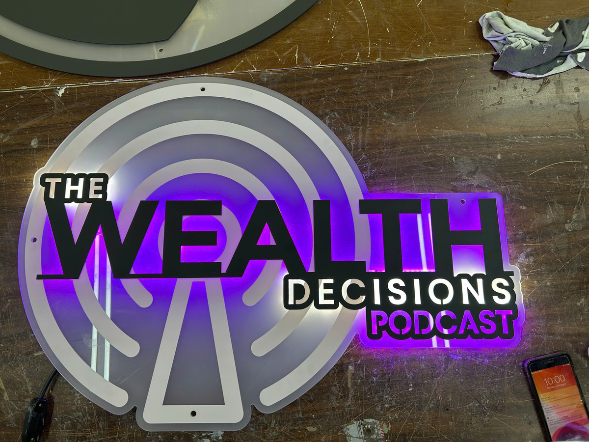 wealth decisions podcast logo on custom metal sign for financial planning